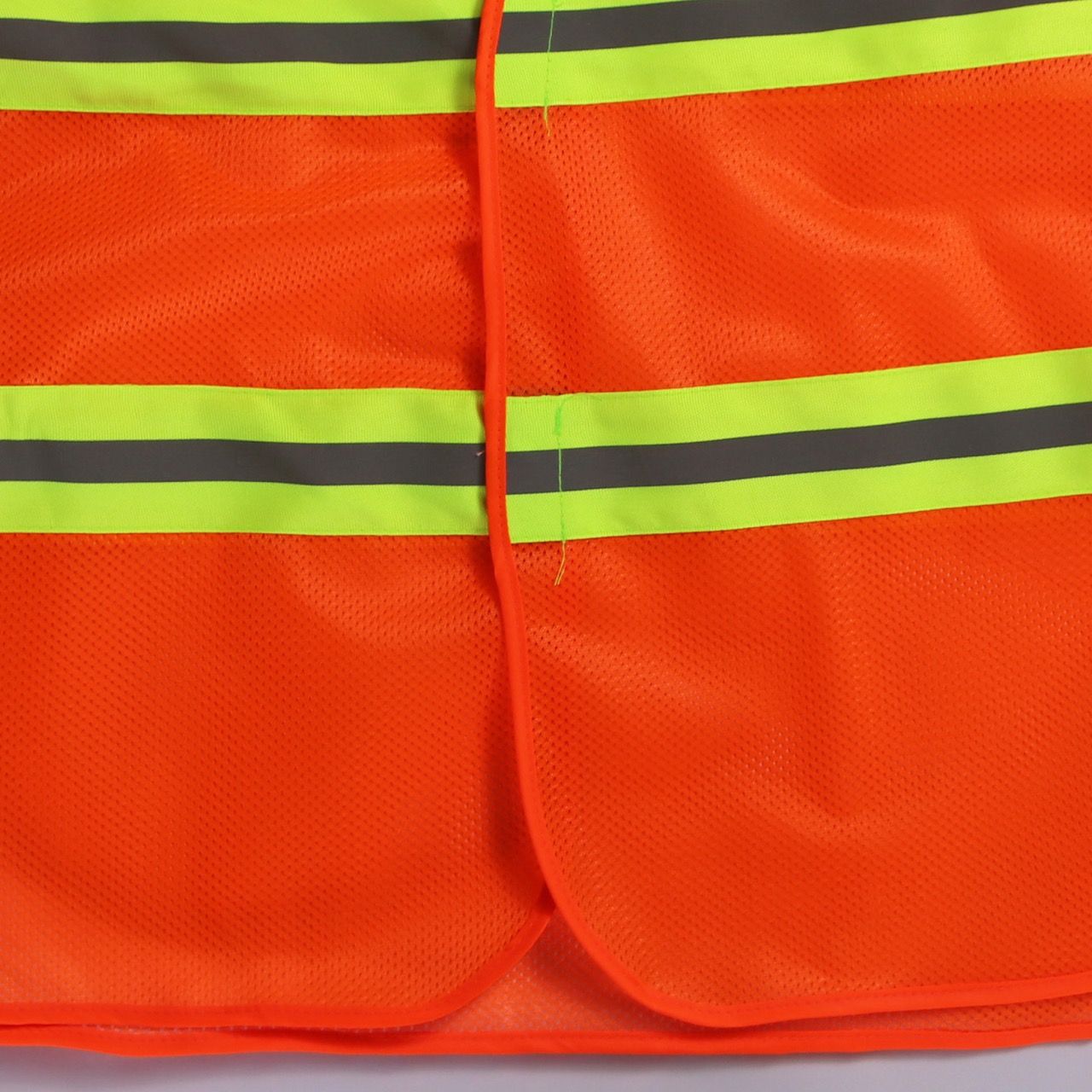 Bright orange mesh reflective vest with two elastic sides and 5cm striped green reflective material.