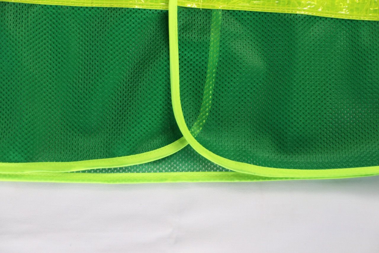 Green reflective mesh vest with elastic sides, featuring banana-checkered plastic reflective material