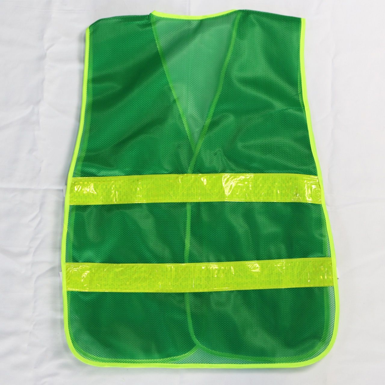Green reflective mesh vest with elastic sides, featuring banana-checkered plastic reflective material